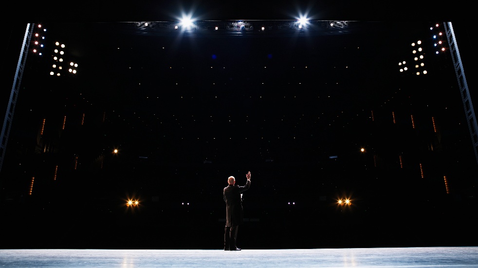 man performing on dark stage
